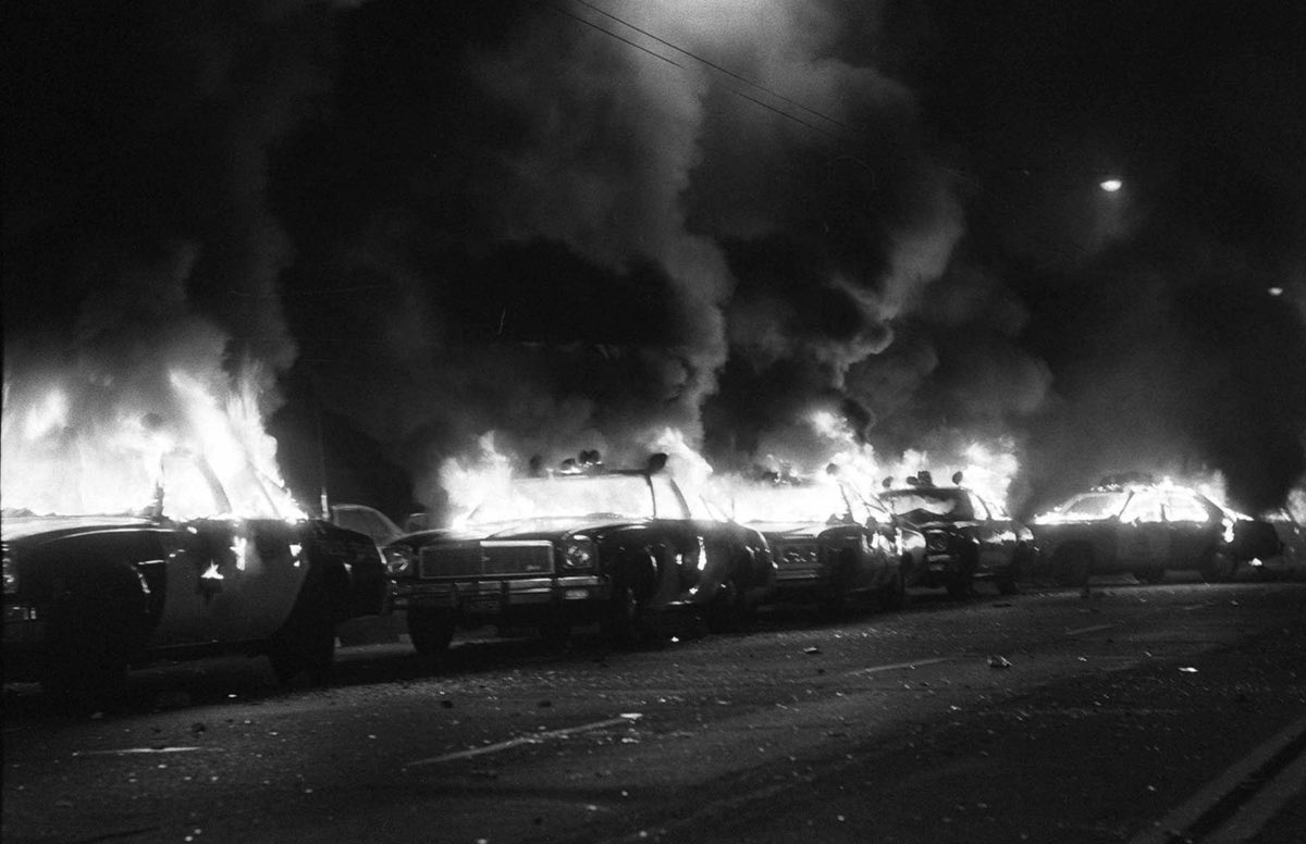 The meme is a black-and-white image of a crowded parking lot on fire, with flames engulfing rows of cars. The image is captioned "when you finally understand the parking situation at the gas station". The meme is likely referencing a frustrating or chaotic situation, and the image is a humorous exaggeration of that feeling.
